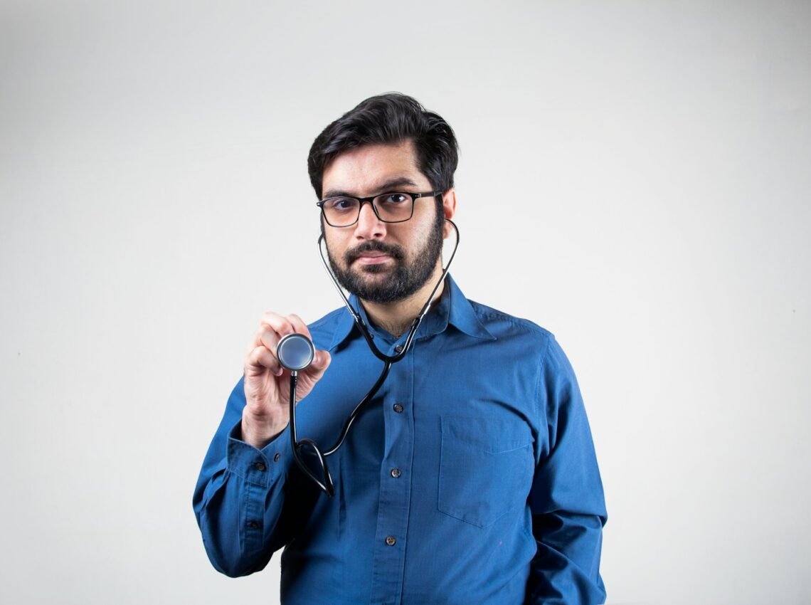 man in blue dress shirt smiling