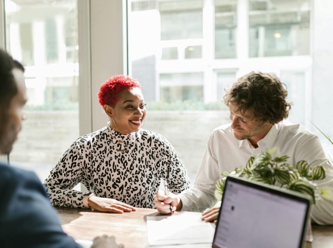 Man in Black and White Long Sleeve Shirt Sitting Beside Woman in White Long Sleeve Shirt