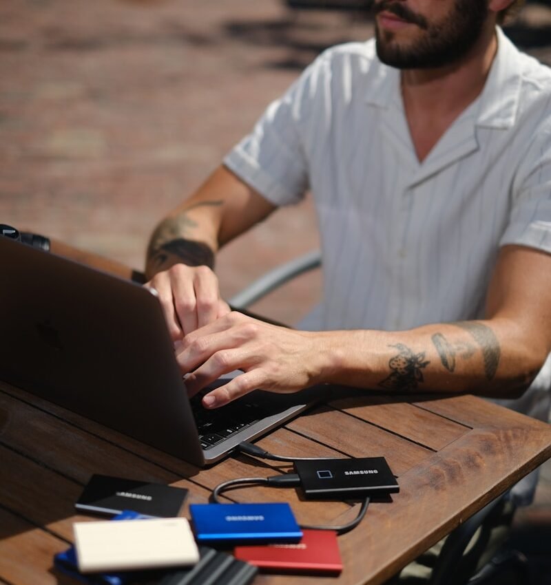 a man sitting at a table with a laptop