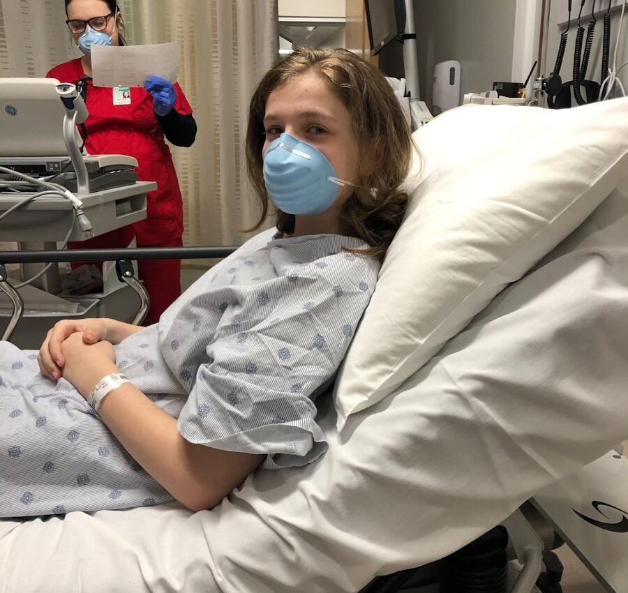 woman lying on hospital bed